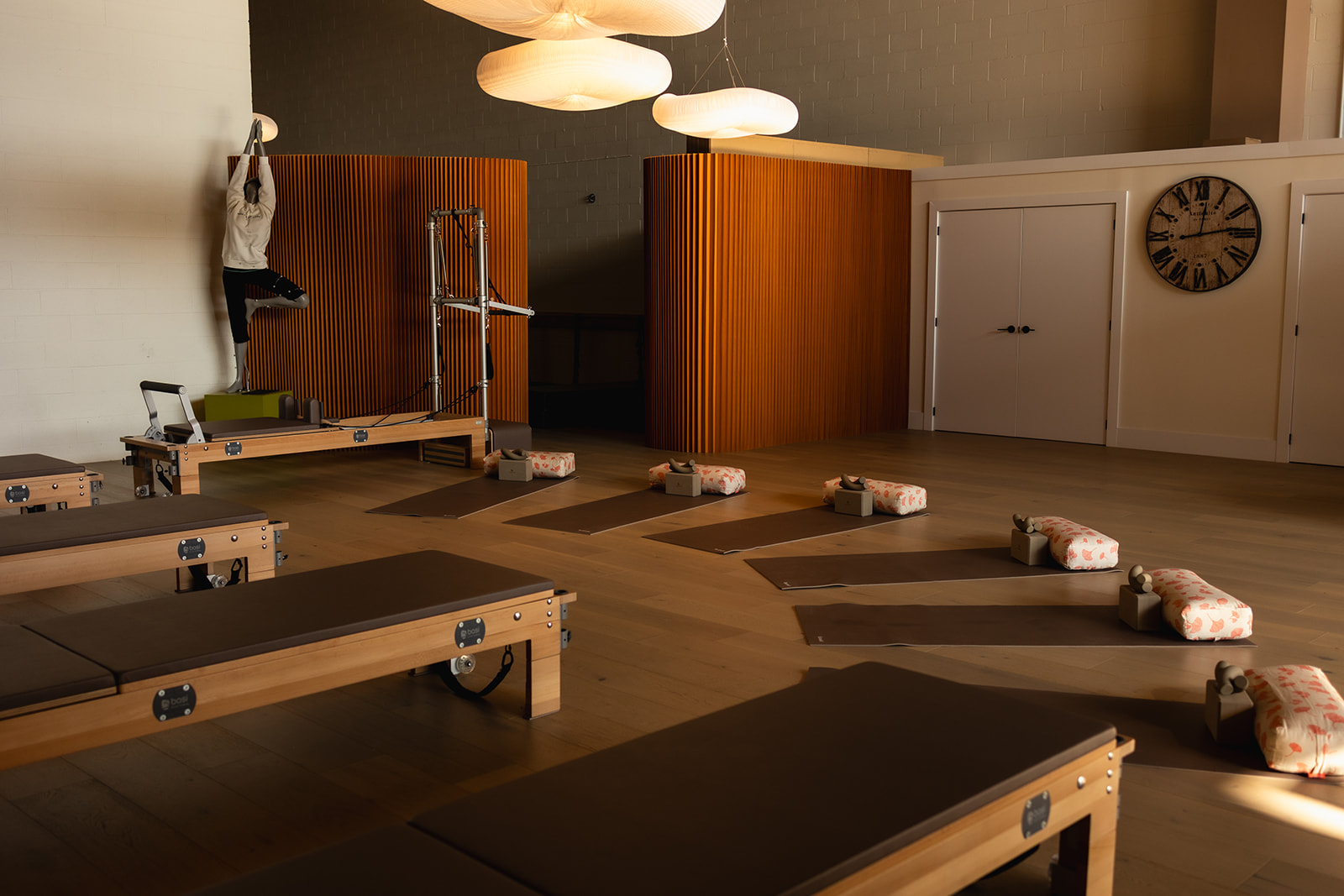 Inside the Titan Pilates studio, Reformers and mats set up for a class