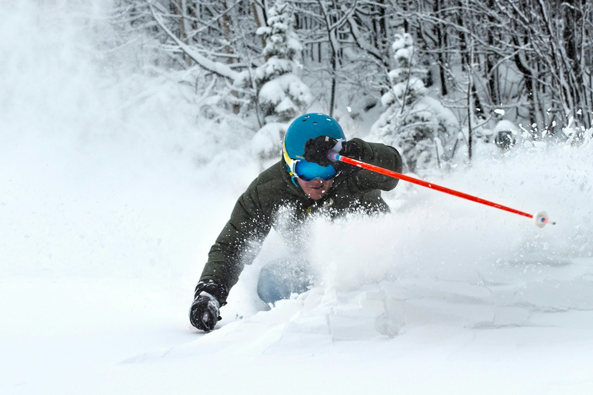 Skier carving through fresh snow near Blue Mountain